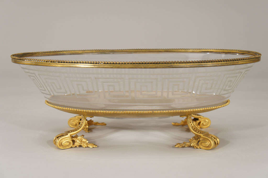 This unusually large footed centerpiece features a hand blown crystal oval bowl with engraved Greek Key cut decoration. The base has elaborate splayed feet and solid oval base with beading all around. The bowl is also mounted with the same beaded