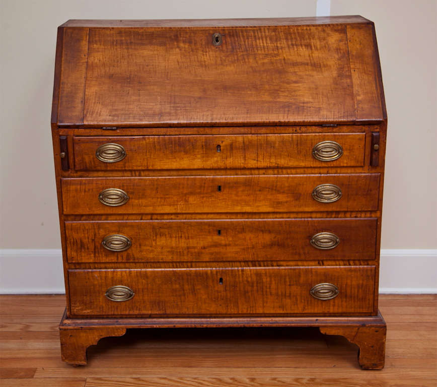 Tiger maple Connecticut style drop lid desk.- Circa 1782- Original hardware-
wheels under legs--Interior wood spruce--Desk supported by pull out runners
and hinges--Key not available-- Hand dove tail----8 1/2