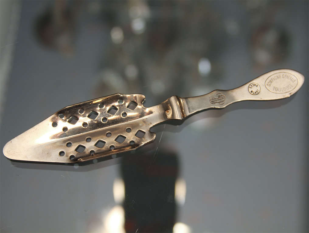 Silver plate absinthe spoon stamped with the brand name, Toulouse, and the owner's monogram 