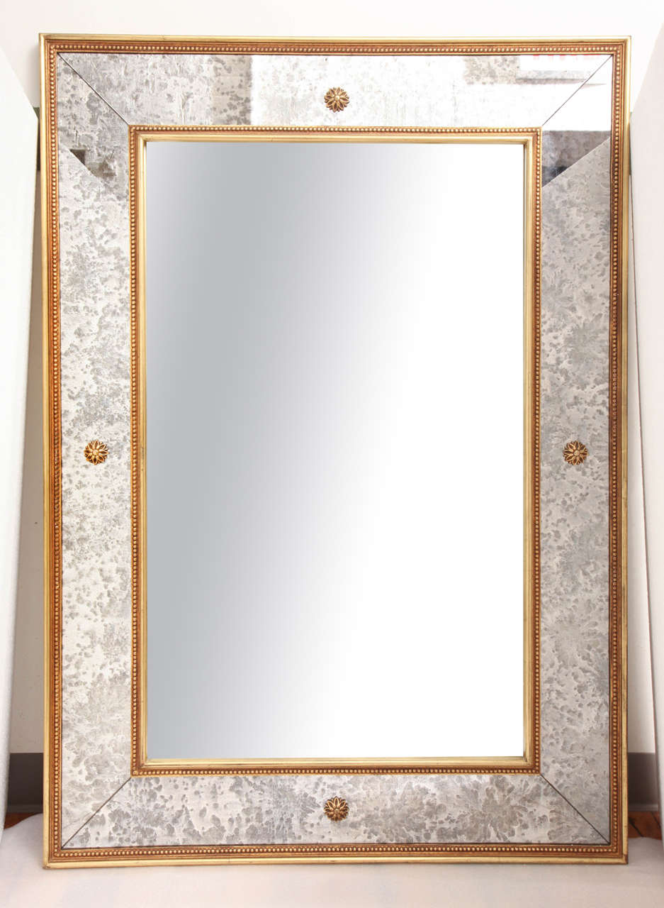 An Art Deco wall mirror with a Bois Dore frame and eglomise border.