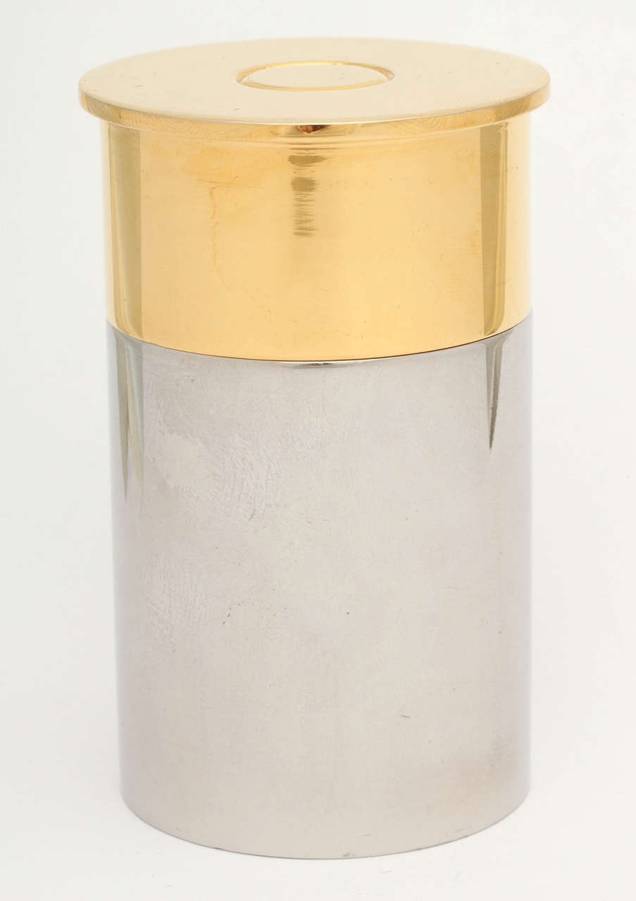 A novel and wonderful quality gas table lighter in the form of a shotgun cartridge. The piece is silver plate and gold plated on the top. The gold plated element lifts off to expose the lighter. 

The lighter is in working order and will simply