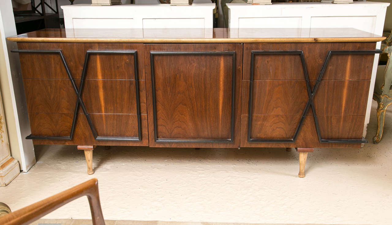 Mid-Century Modern rosewood sideboard or console. Three drawers, one-door with three interior drawers flanked by three more drawers adorn this fantastic XO designed piece. A beautiful rosewood makes this a stunning piece; the ebonized XO design