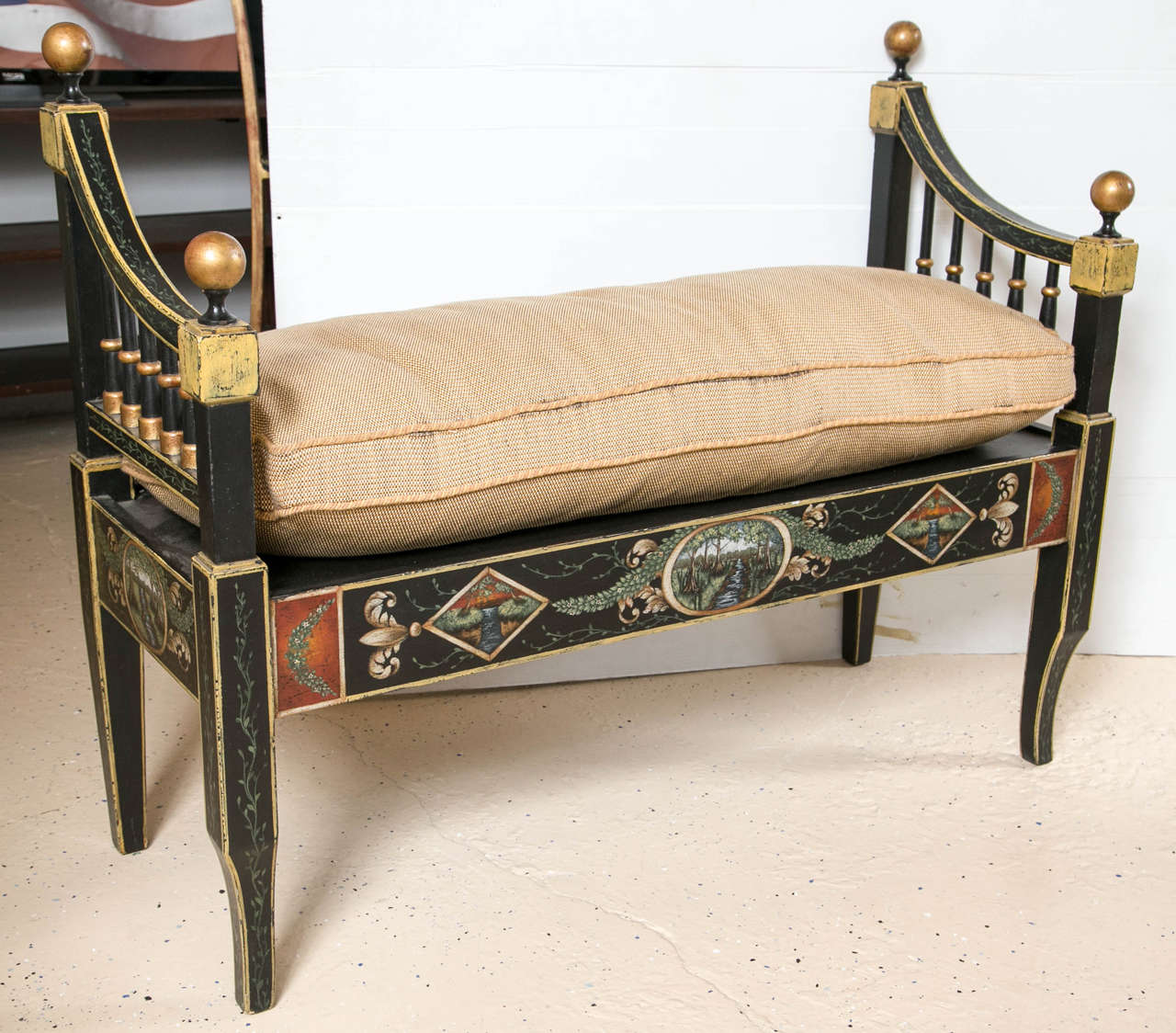 Pair of Hollywood Regency style ebonized and paint decorated benches. The curved and gilt gold decorated ebonized feet supporting an upper sitting bench with a finely paint decorated apron. The center of the apron having a stream in a forest with