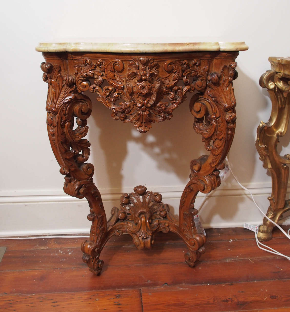 Pair of Louis XV carved walnut wall-mounted console tables with marble tops.
Having the typical rocaille motifs of the Louis XV period and Sienna marble tops.