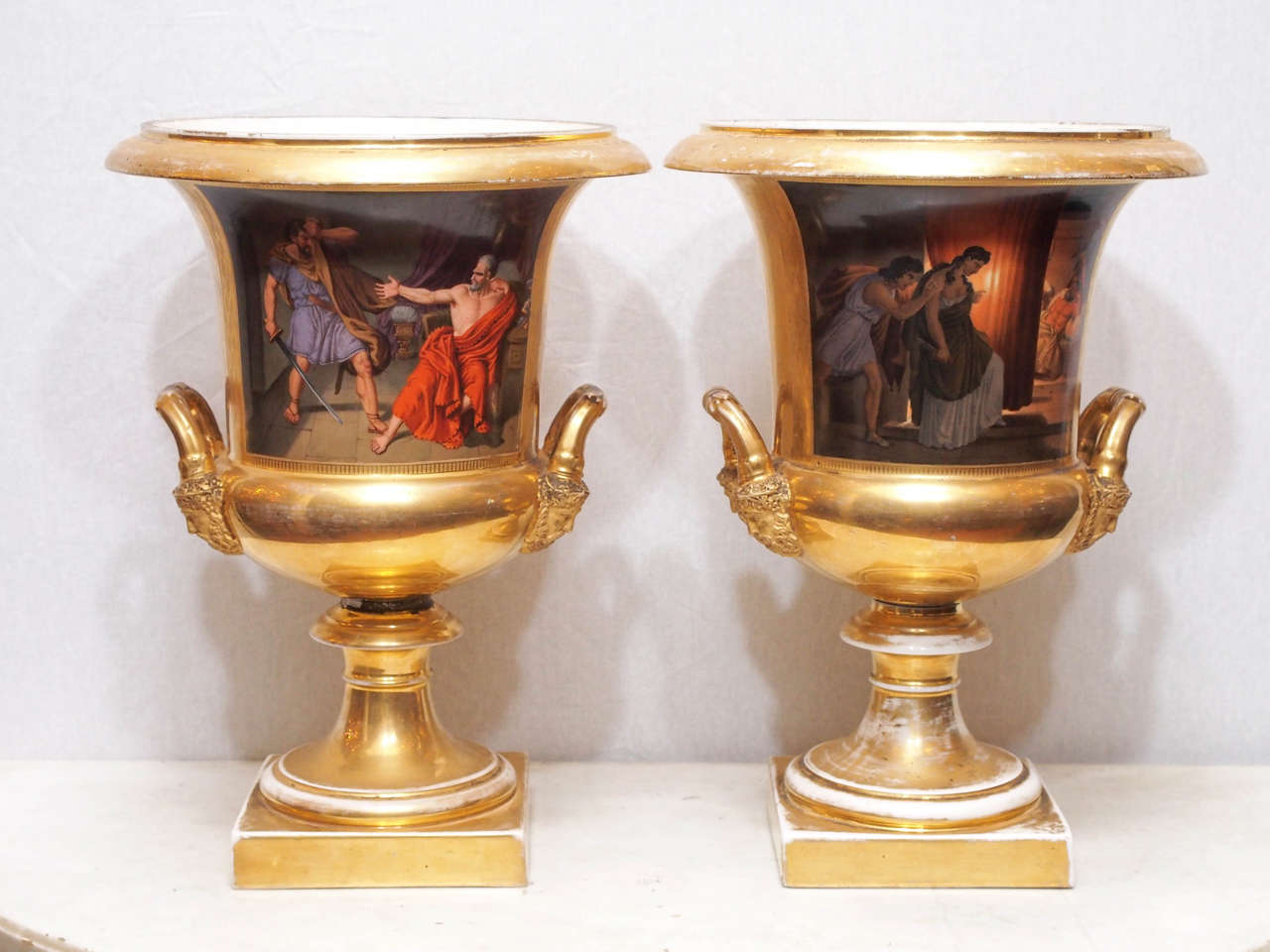 Pair of Gilt Porcelain Vieux Paris Campagna Urns with Classical Scenes.