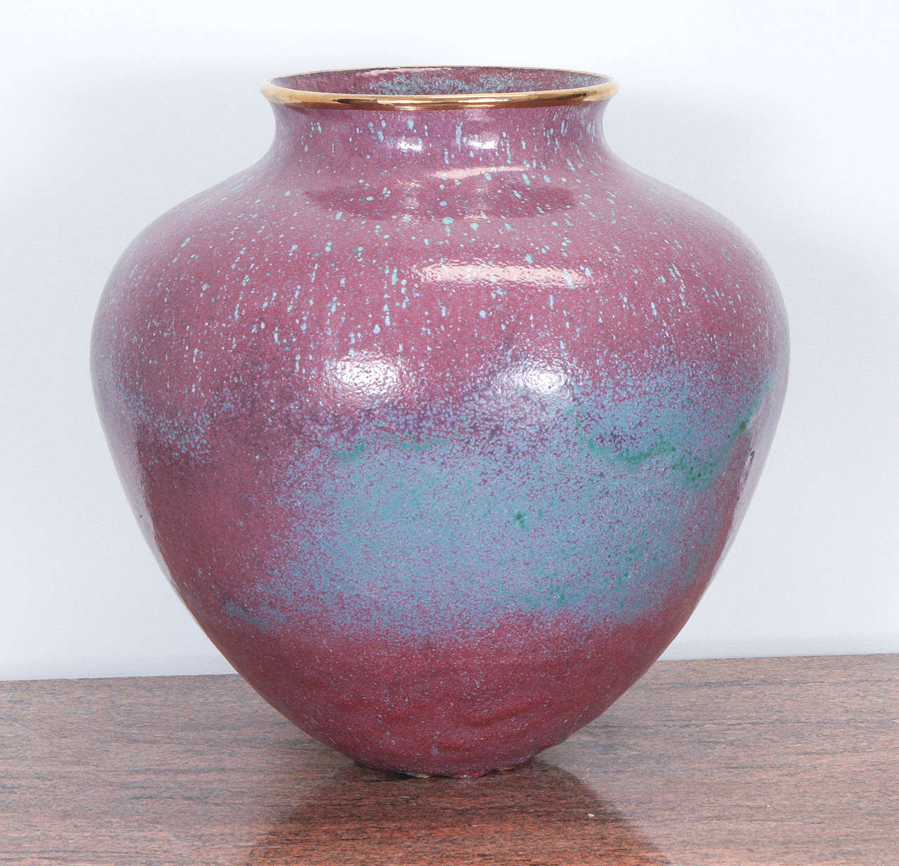 Spectacular large ceramic vase with a beautiful dusky rose crystalline glaze finish. The glaze finish has a mottled effect with hints of teal and gilded lip. 
The vase was custom-made by Steven Klinsky for Mr. Chase and used in a Steve Chase Indian