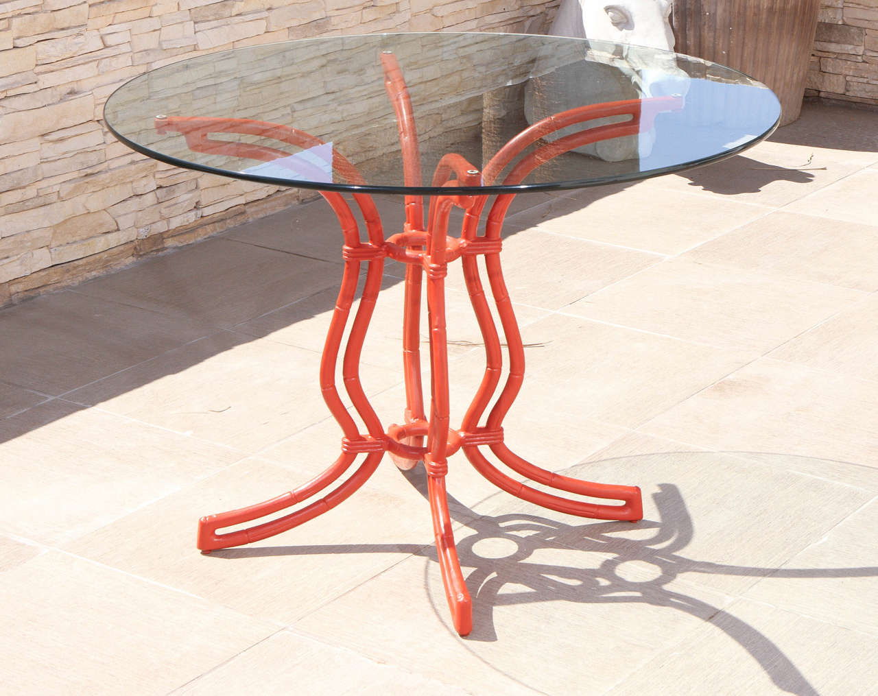 Elegant chinoiserie dining table and four chairs constructed of metal frames, which are finished in a rich Chinese red color. The table which is 29