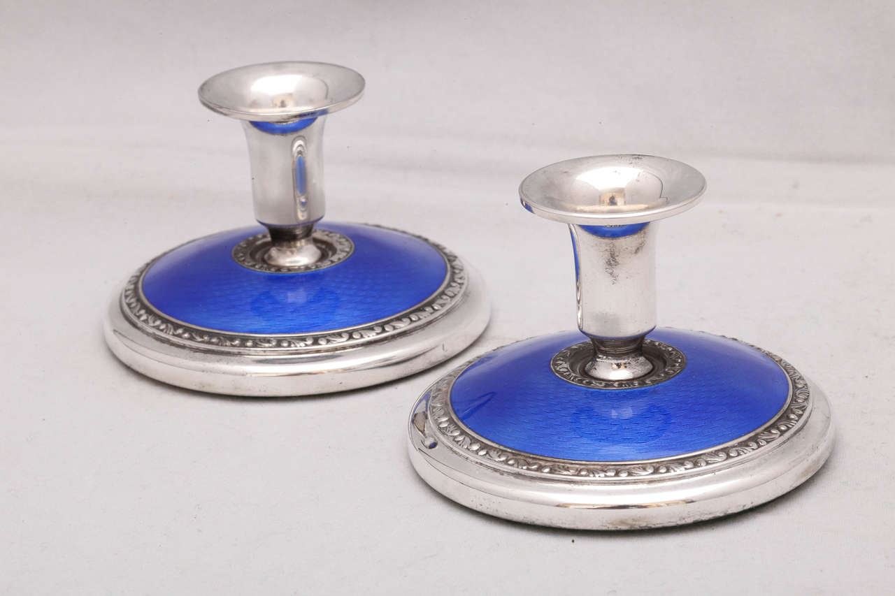 Pair of Art Deco, sterling silver and dark blue guilloche enamel candlesticks, Norway, circa 1920s-1930s, Norsk Solwarreindustri makers. Dimensions: 2
