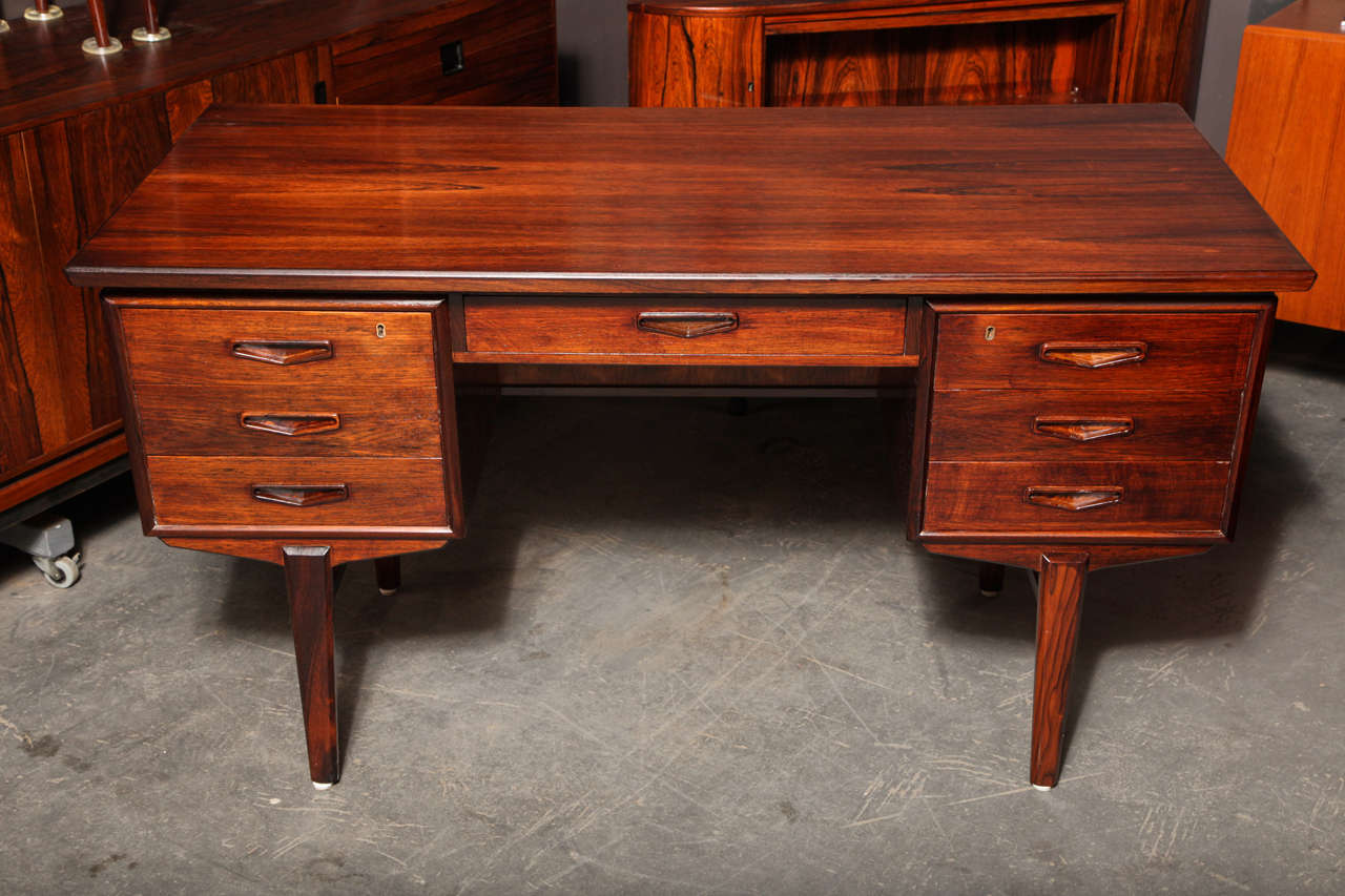 Vintage 1960s Danish Desk in Rosewood.

This Vintage Desk in in like-new condition has a cool slanted front, a pull-out filing cabinet, and two book shelves on the back. This beautiful medium-sized desk is perfect for home or office. Ready for