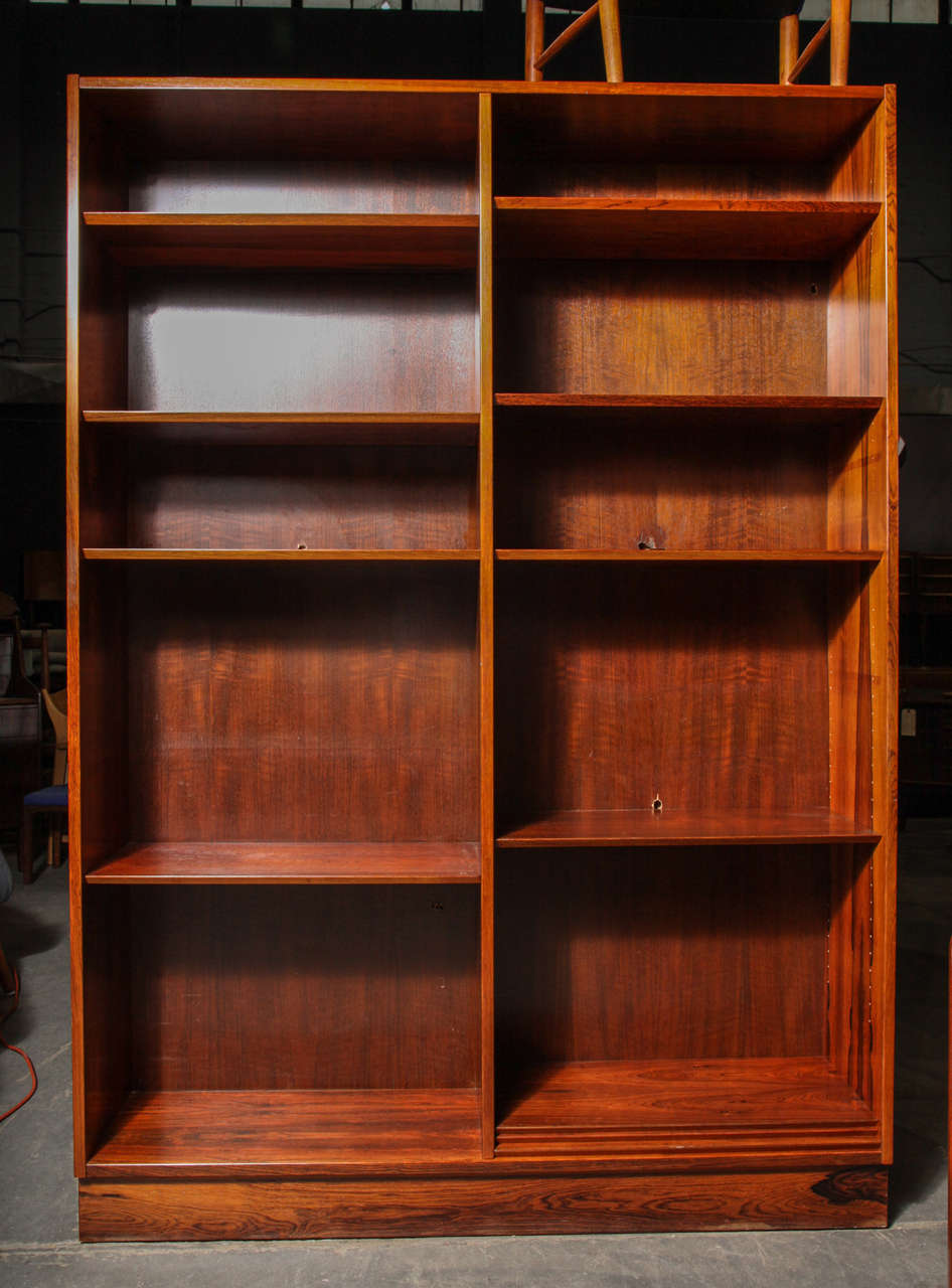 Vintage 1960s Poul Hundevad Rosewood Bookcase.

This Vintage Bookcase is in vintage condition. The outer walls of the case are perfect, but someone along the way drilled a few small holes in the back to run a cord out of the back. These holes will