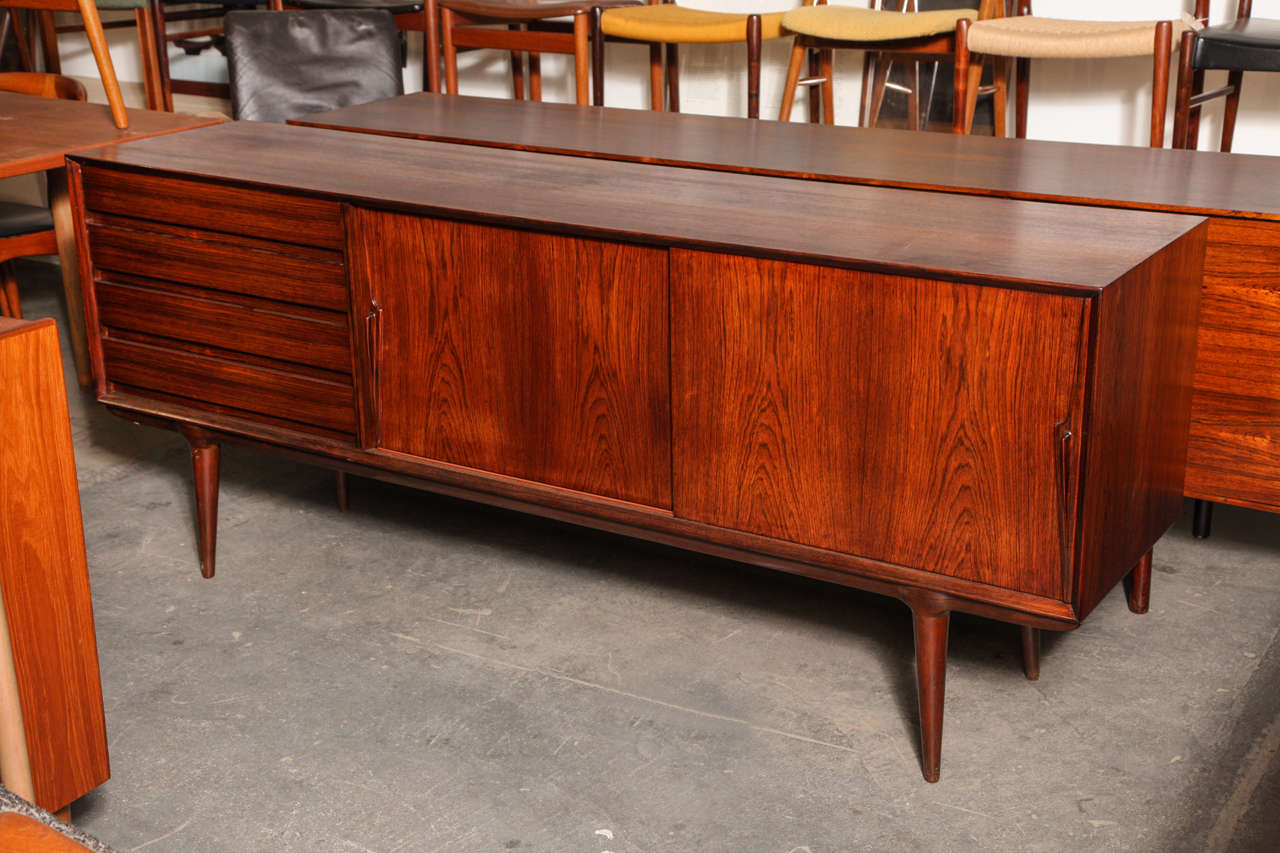 Vintage 1960s Rosewood Sideboard by Omaan Junior.

This Vintage Danish Cabinet is in like new condition. The perfect balance of drawers and shelves. Great for use in your living room for a media cabinet, in the bedroom for clothing storage, in the