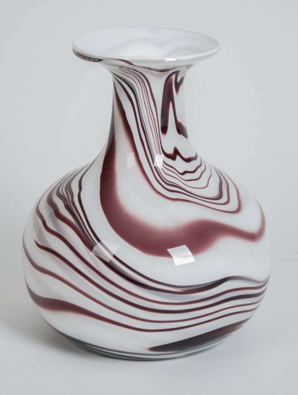 A beautiful vintage 1970s Carlo Moretti maroon and white waves glass vase. 

By Carlo Moretti
