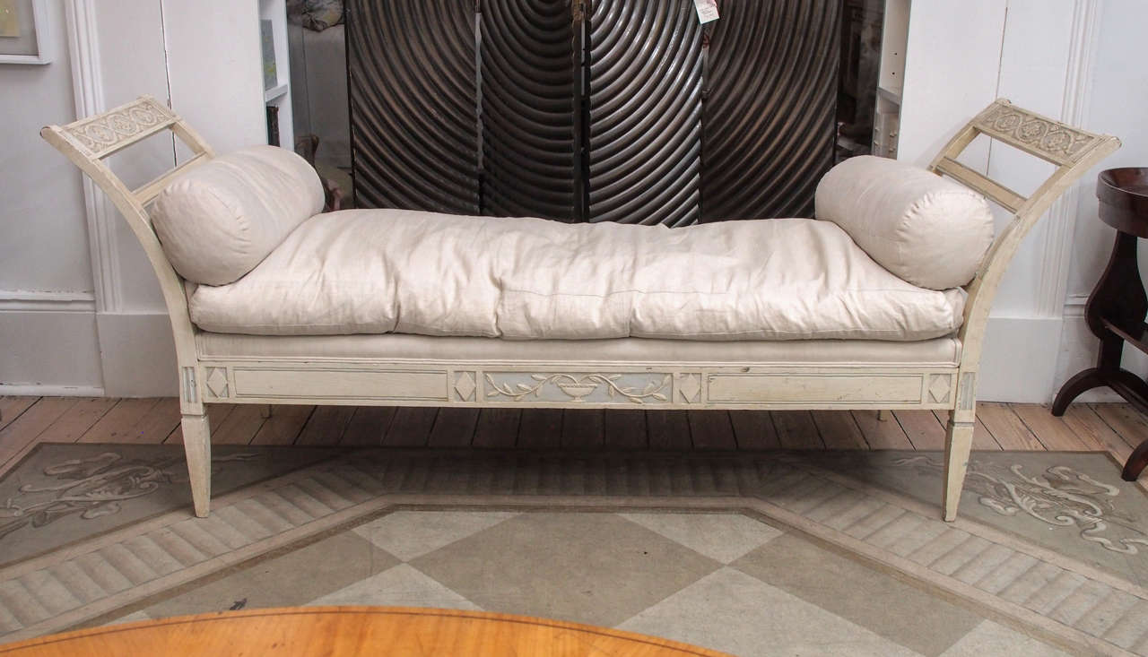 Off white painted and carved wooden daybed with cushion top and