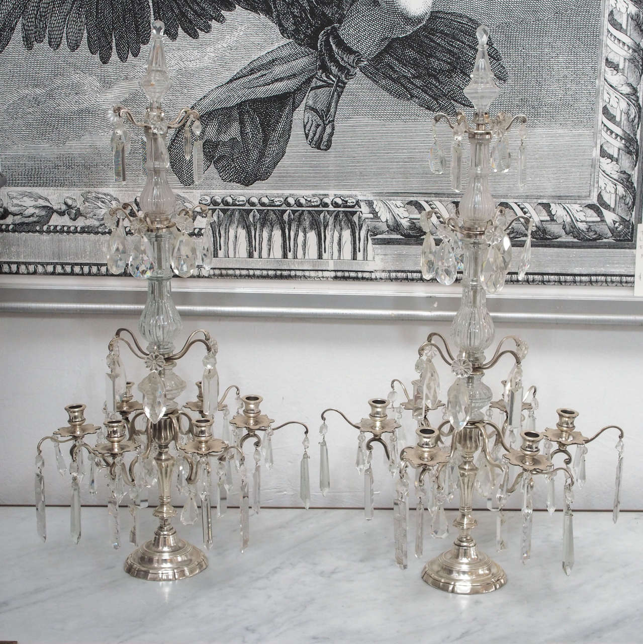 Pair of silver plate girandoles, in the Louis XV style, France, circa 1900. The candle stick shaped base supports a glass clad standard from which issue four tiers. The bottom tier has six silver plated arms terminating in silver plated tulip cups
