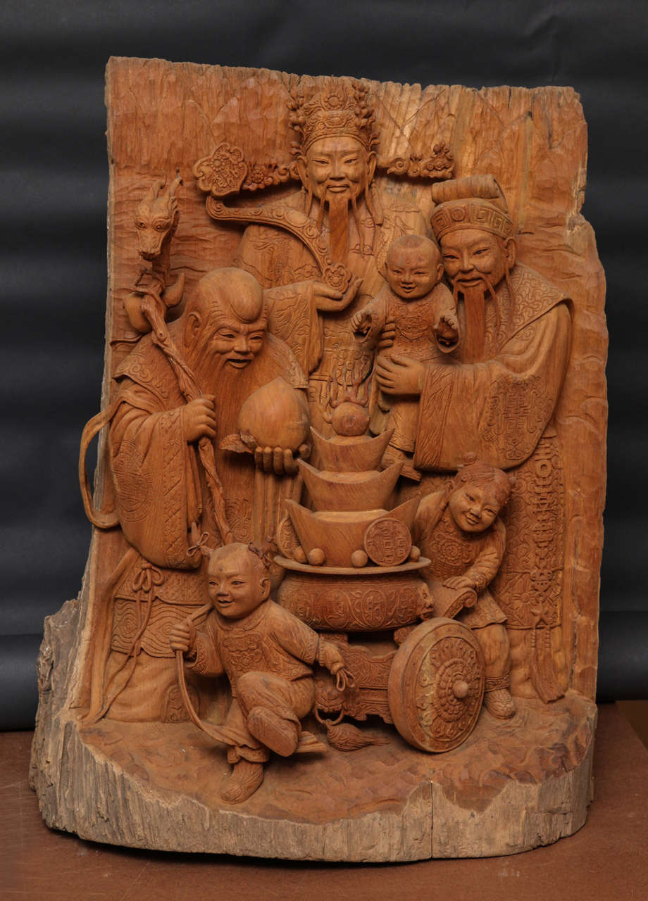 A very high quality carving of the three lucky Gods of Chinese Taoism: longevity, prosperity and good fortune . depicted with a cart of money ingots, and children.  Carved from a single block of teak wood.