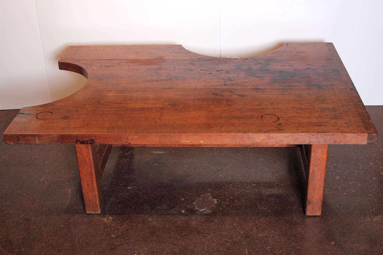 
From Languedoc region of France, circa 1920s. 

This table was once counter height and belonged to a French jeweler. The half circles, was where the jeweler would stand to make his jewelry. There is a piece of wood that sticks out from one of