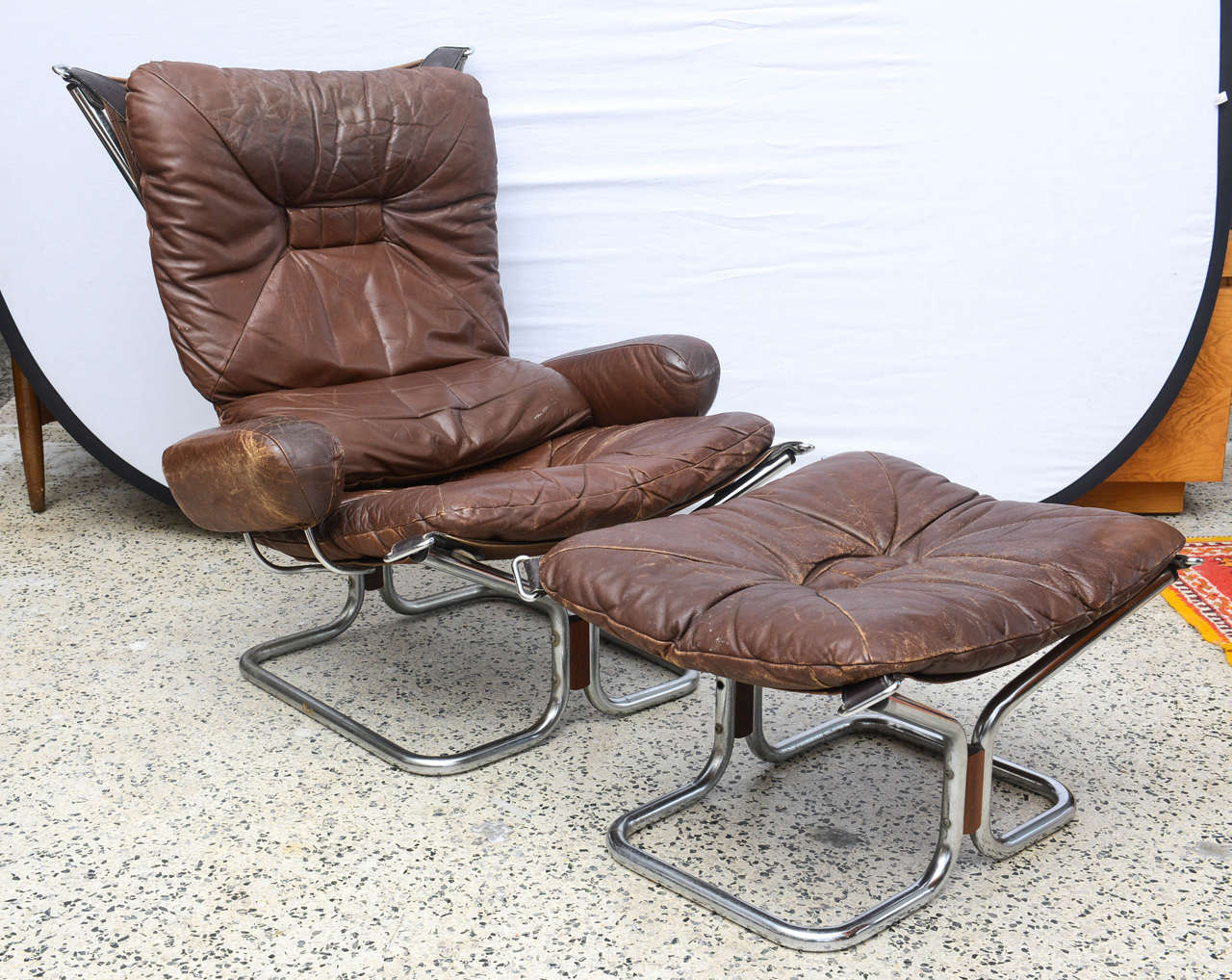 Wonderful vintage MCM chrome and leather with Rosewood accents chair and  ottoman by Ingmar Relling.  Norway 1970s.