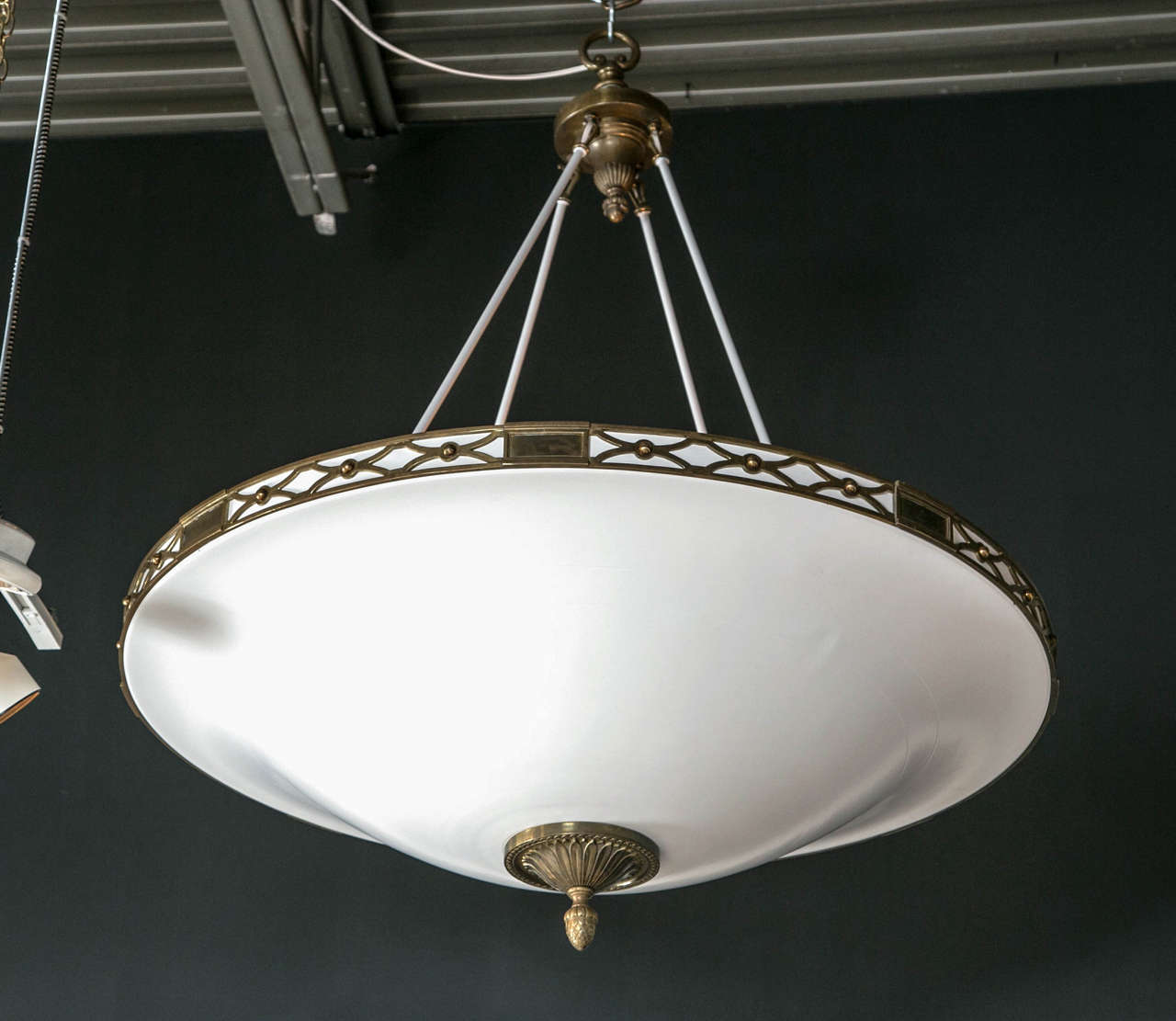 A large white painted dish shape metal chandelier with brass band decor. Newly rewired.