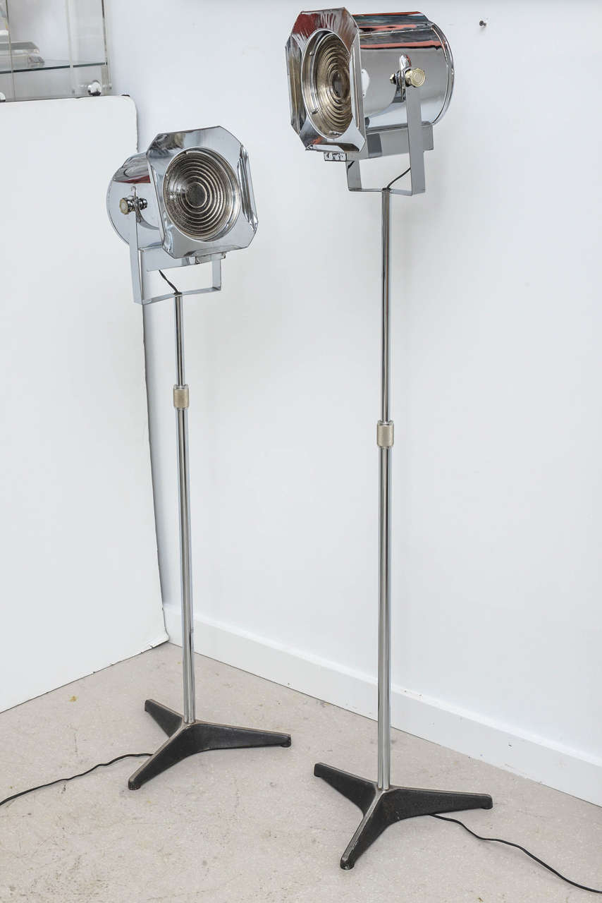 Pair of vintage chrome photographer lamps with foot pedal switch. Both spot lights are adjustable in height and evoke the feeling of old Hollywood.