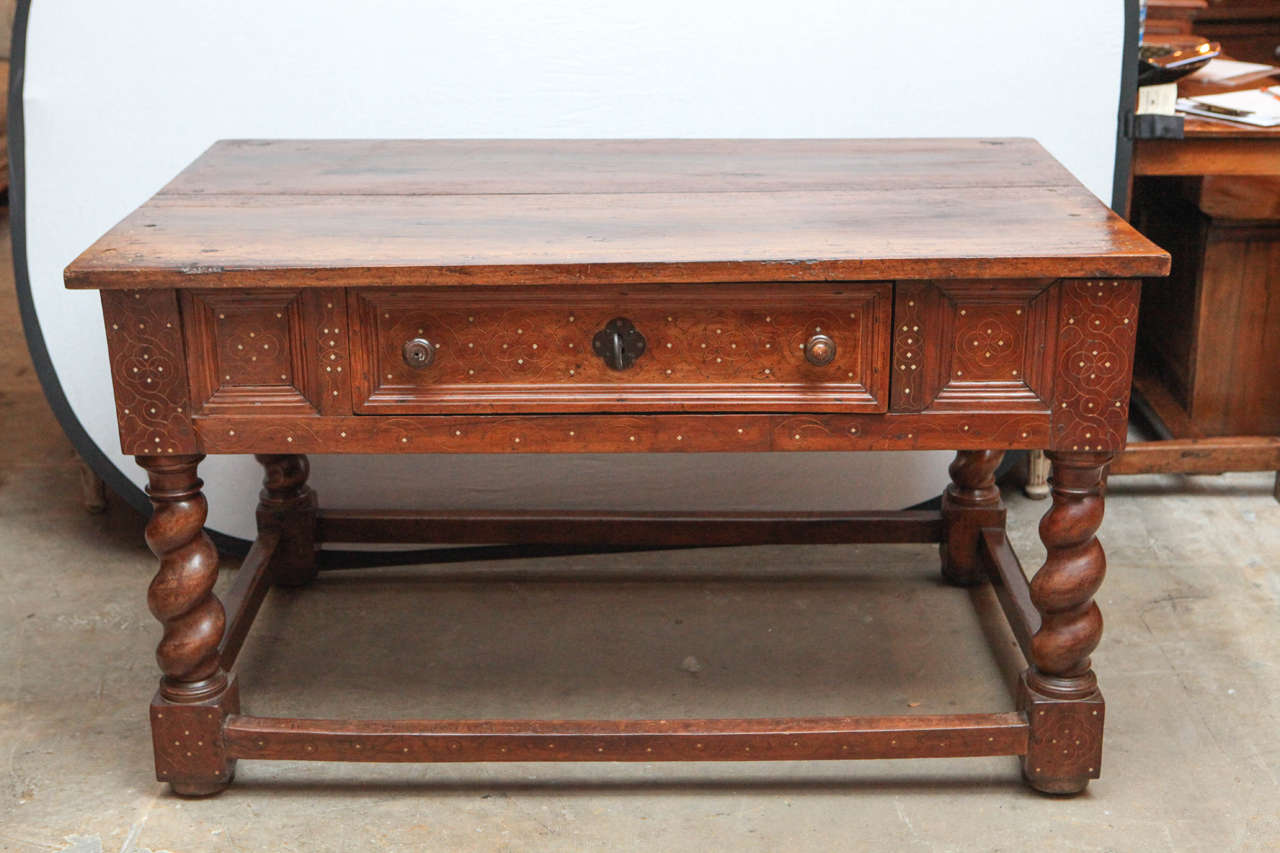 Early 18th century Italian walnut two-drawer table with fruitwood and bone inlay. The table can be floated in the center of a room as it is finished on all sides. The table features twisted legs and the original key is included.