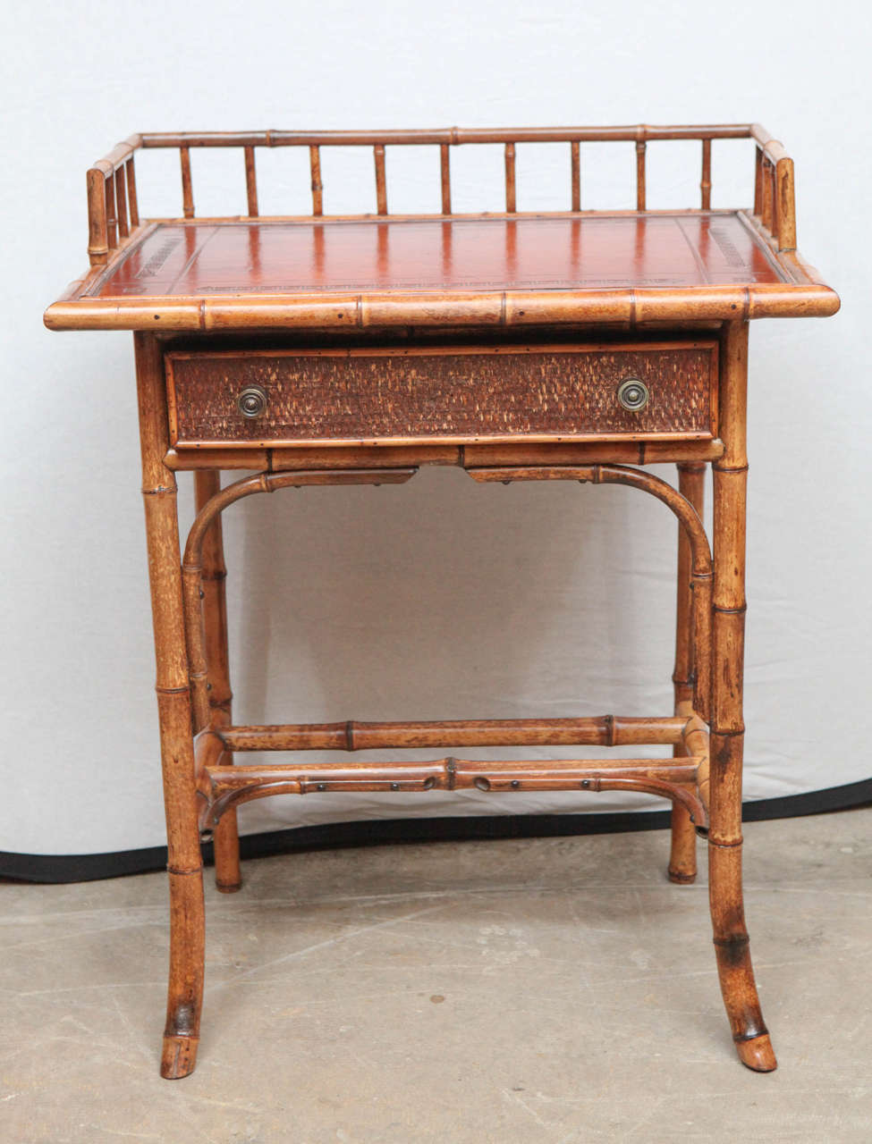 19th century English bamboo writing table with single drawer and tooled leather top. Can also be used as nightstand or end table.