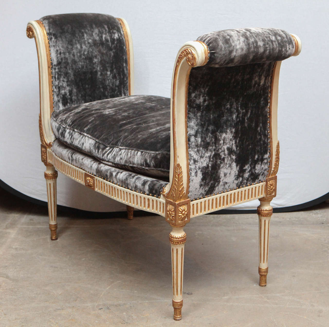 Giltwood and Painted French Style Curled Arm Bench with Gray Velvet Upholstery. They are 22k gilt and painted. The price quoted below is for one bench but there are two benches available.   (not antique)