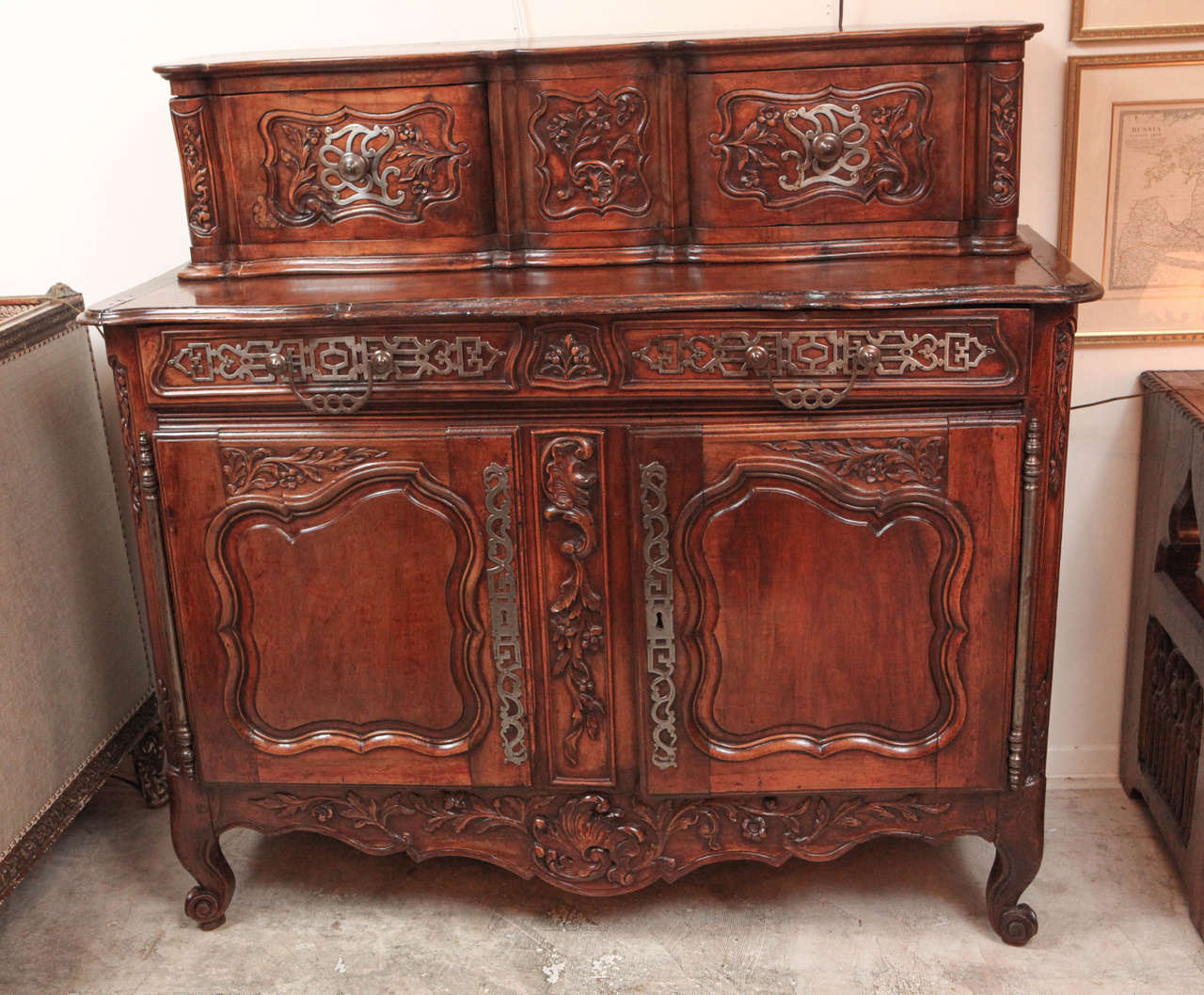 18th century very finely carved French walnut two-part sideboard with original iron hardware.