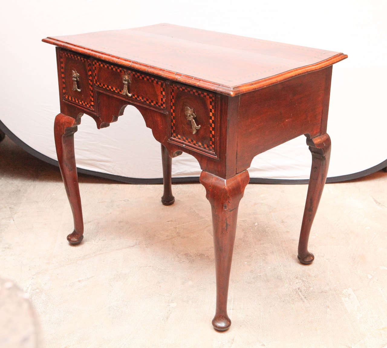 Early 19th century English inlaid three-drawer walnut low boy end table with satinwood and mahogany inlays.