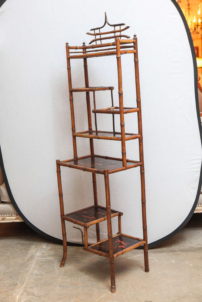 19th century English bamboo etagere with chinoiserie and black lacquered panels.
