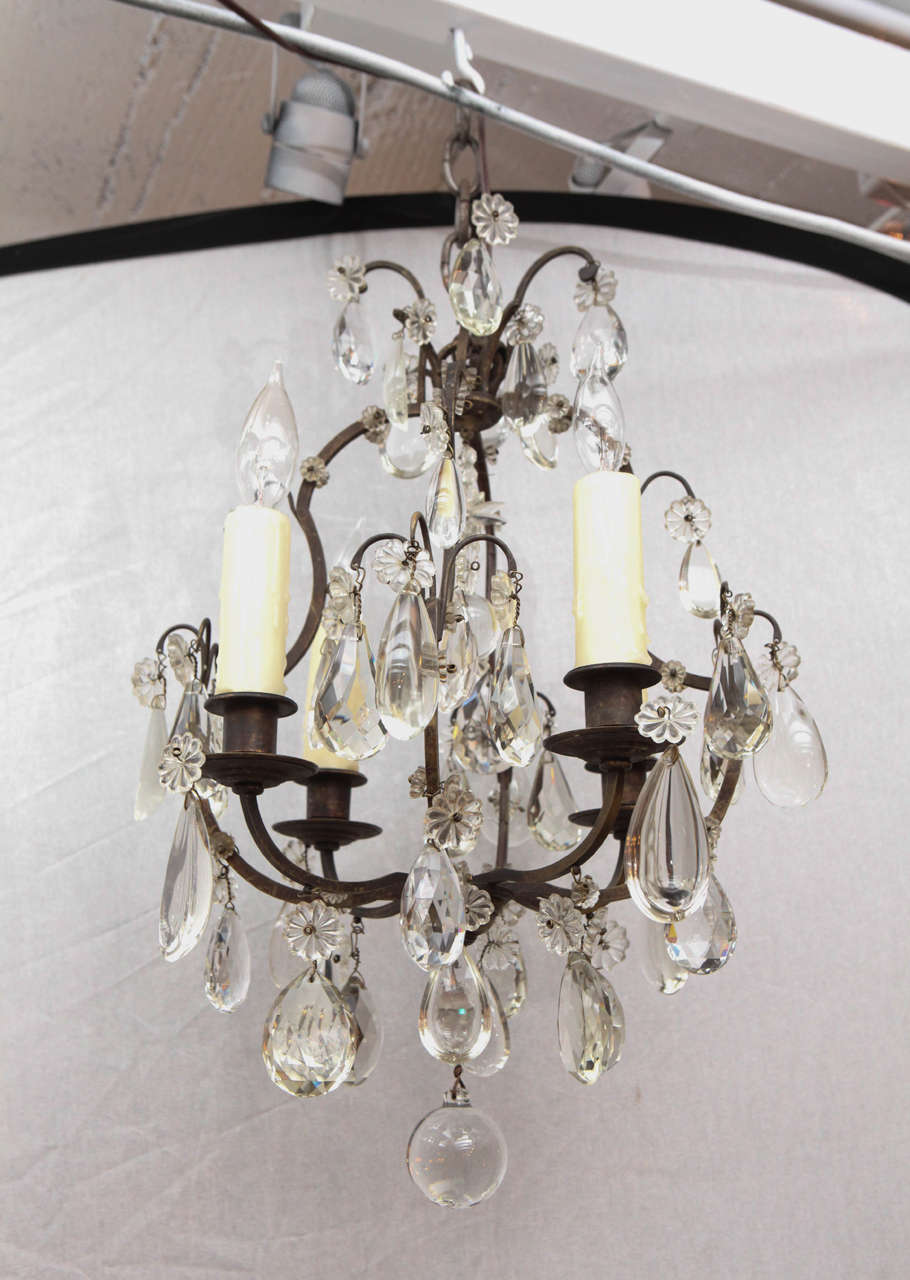 1900s French bronze and crystal chandelier. The chandelier has four lights and has been newly wired.