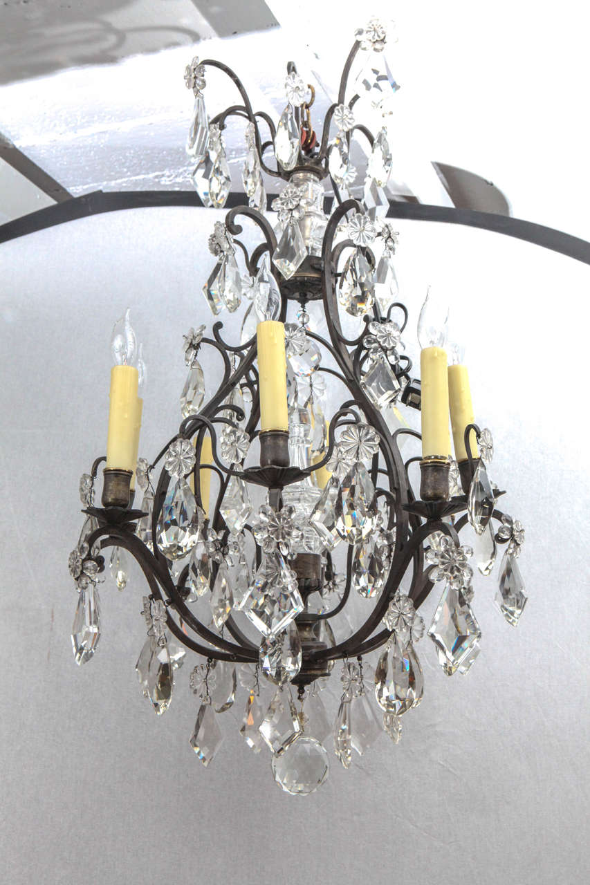 1900s French bronze black framed crystal chandelier. This chandelier has eight lights and has been newly wired.