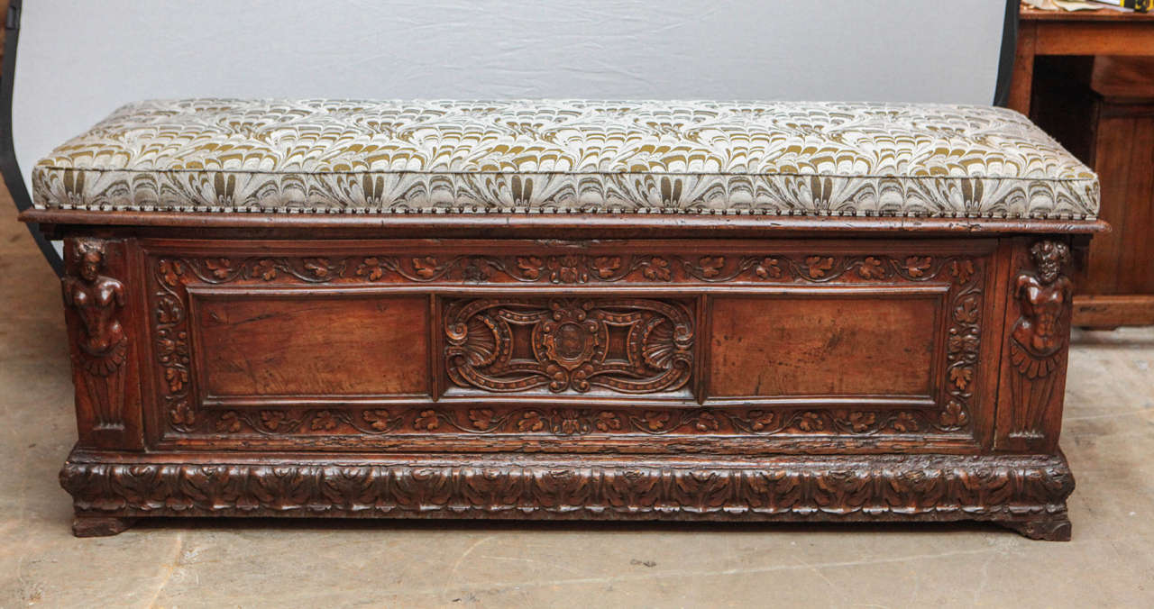 18th century Italian walnut cassone with Donghia upholstered top. Fine carved and paw feet.