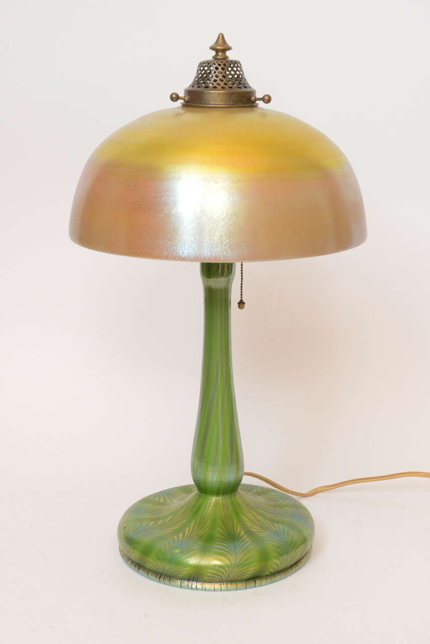 A Louis Comfort Tiffany Favrile glass table lamp signed LCT on shade and base, circa 1900.