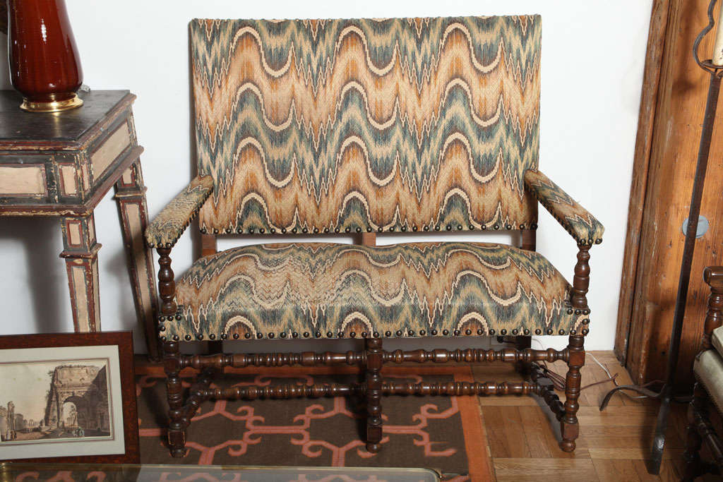 A Pair of Louis XIII Style Carved and Stained Settees or Benches