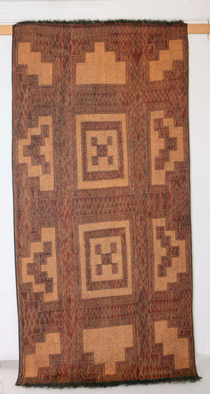 Weavings such as this one were used by the Tuareg tribes of northwest Africa as floor coverings during their nomadic life in the Sahara desert, either within the tent or to cover vast landscapes of sand surrounding their encampments.
The designs