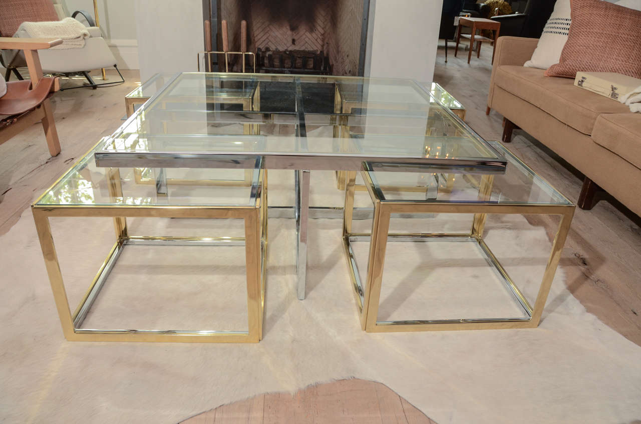 Stunning and very sculptural 1970's Jean Charles coffee table in brass and chrome with glass top and four additional cubes.