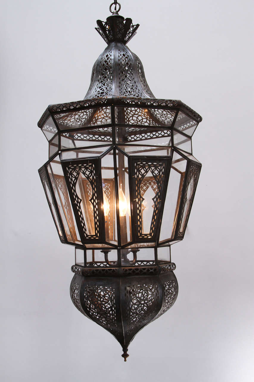 Pair of Moroccan Moorish vintage clear glass with intricate metal filigree hanging chandelier.
Delicately and finely handcrafted by artisans in Marrakech, Morocco. 
Quality art work in bronze metal color finish.
They will be available after 3 to 4
