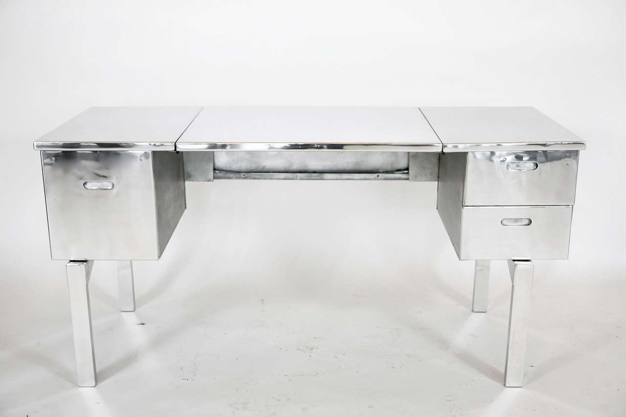 Aluminum campaign desk that was originally used by the US Military. Professionally stripped and polished. Small indents on the surface are part of the design. Perfect for writing desk or vanity and absolutely gorgeous!