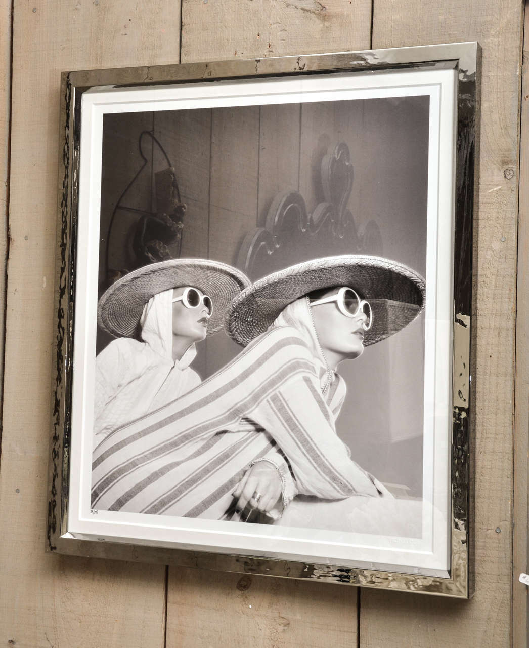 This is one of a series of fashion photographs done by Willie Christie. These photographs were done in the 1970's and 1980's. They are attractively framed in a silver metal frame.
