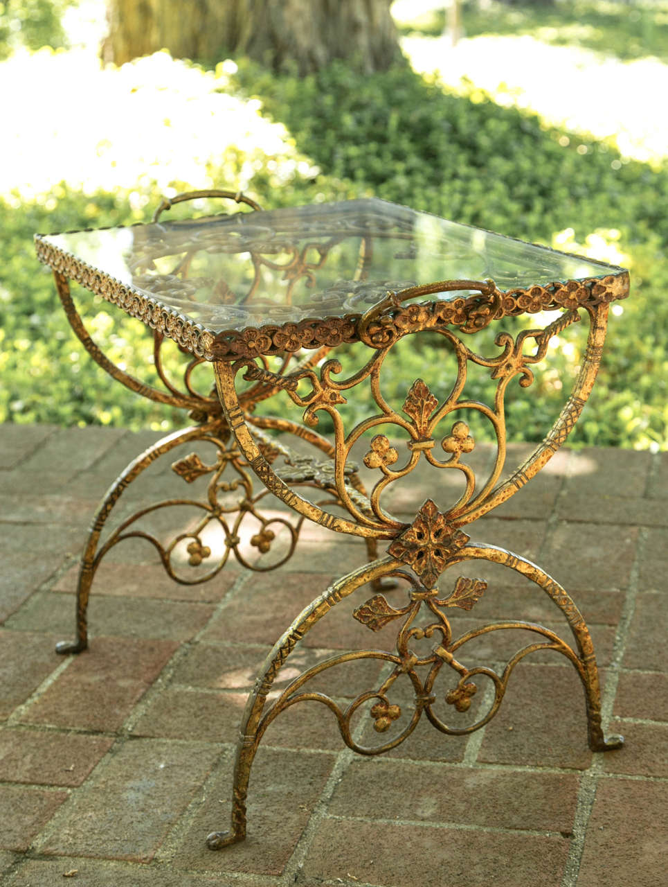Wrought iron and glass tray-topped table in gold paint, in the style of Oscar Bach (German, 1884-1957), metalsmith active in New York City from 1913-1941.
