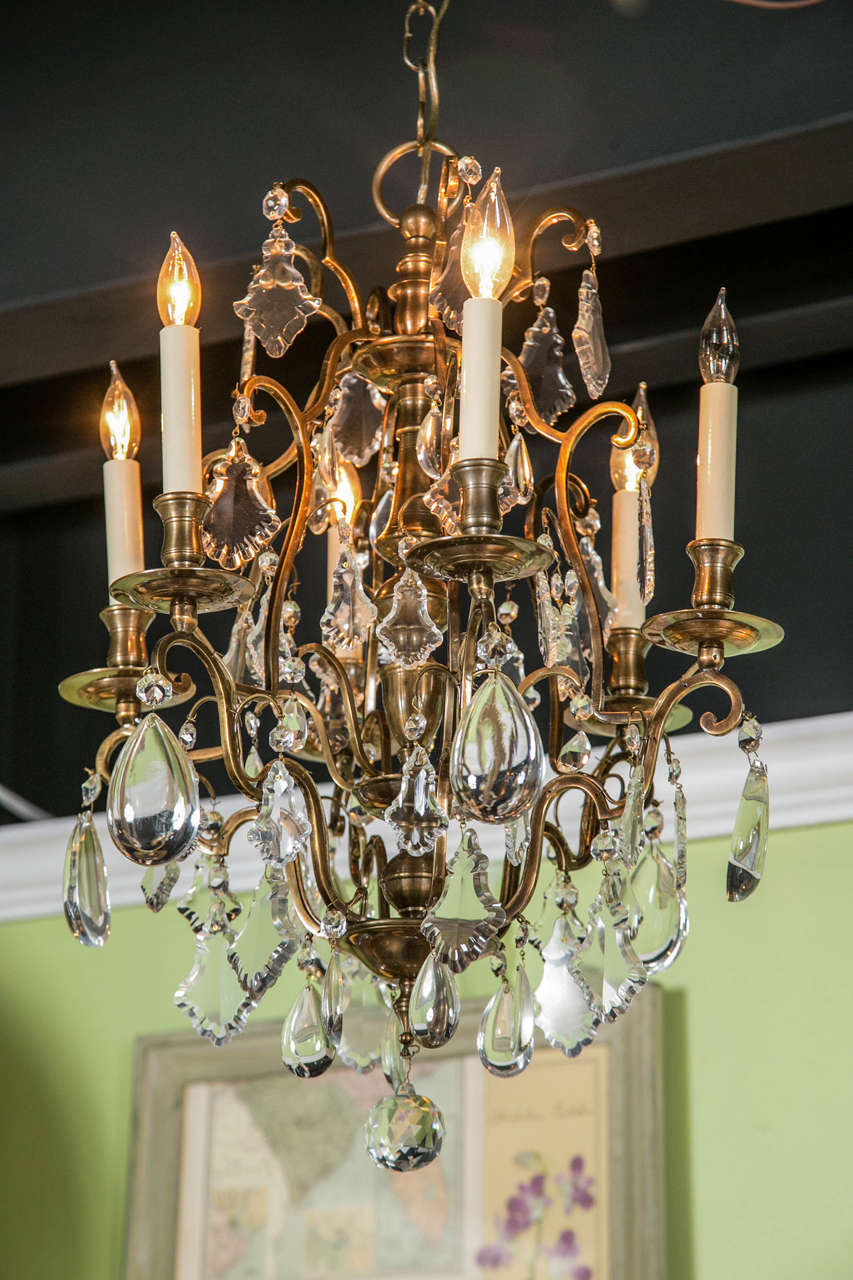 A French bronze and crystal six arm chandelier c. 1940's.
