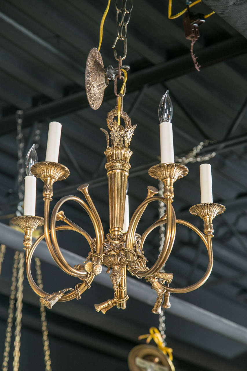 A circa 1930's, cast bronze huntsman horn and tassel five arm chandelier.