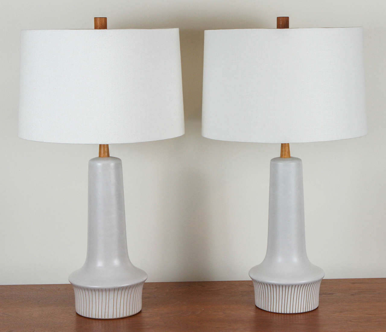Pair of ceramic Martz lamps with sgraffito striped base.