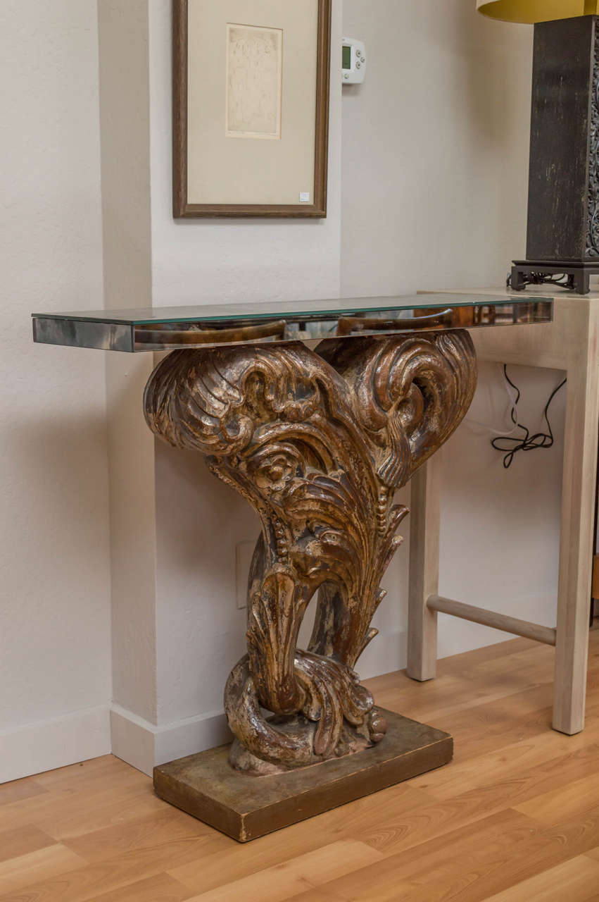 An outstanding circa 1930s console table, attributed to Dorothy Draper, and also Grosfeld House. Smoke mirror top, a cast plaster design, copper & silver gilt over it, with a wooden base.