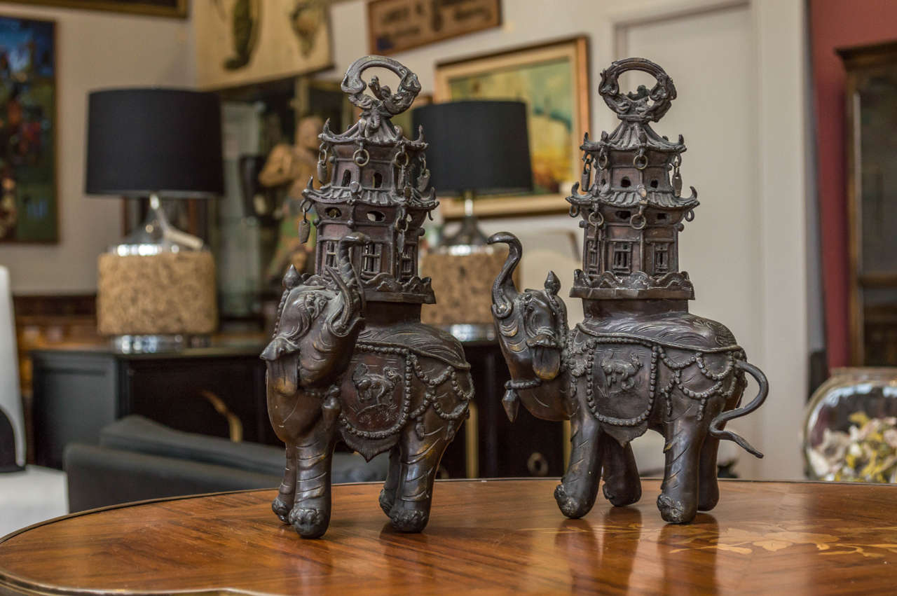 Pair of 19th century bronze elephants, both with two tiered pagodas on their backs, on the very top of the pagodas are serpents. Each incense burner comes in two pieces.