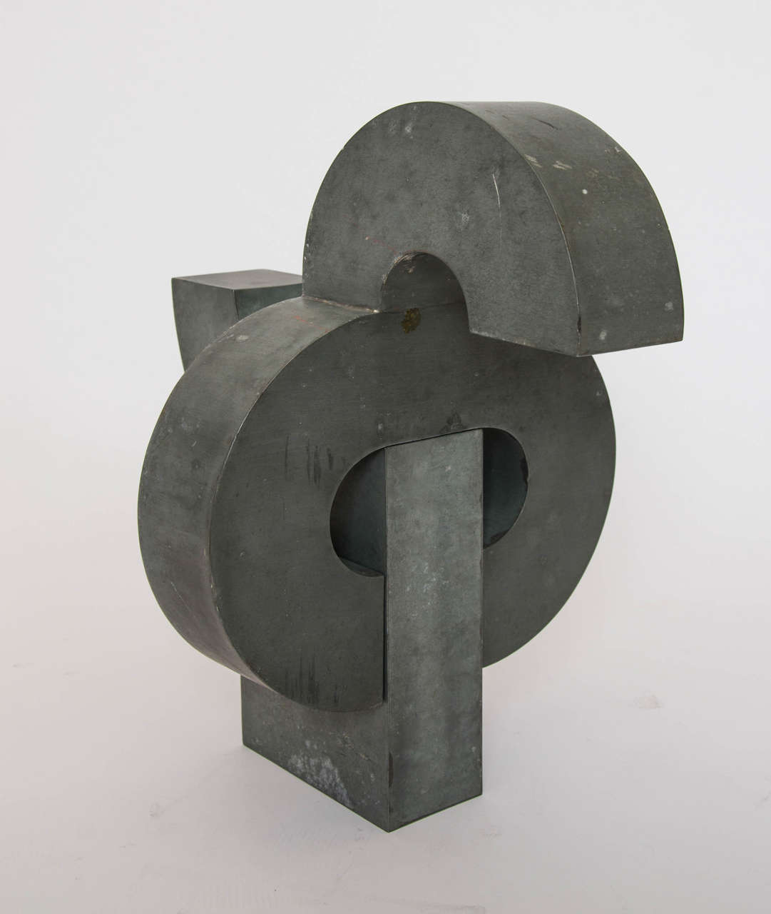 Geometric sculpture welded in zinc sheet metal. This sculpture is cleverly constructed in two parts giving the appearance of interlocking forms which can take different shapes by changing position.