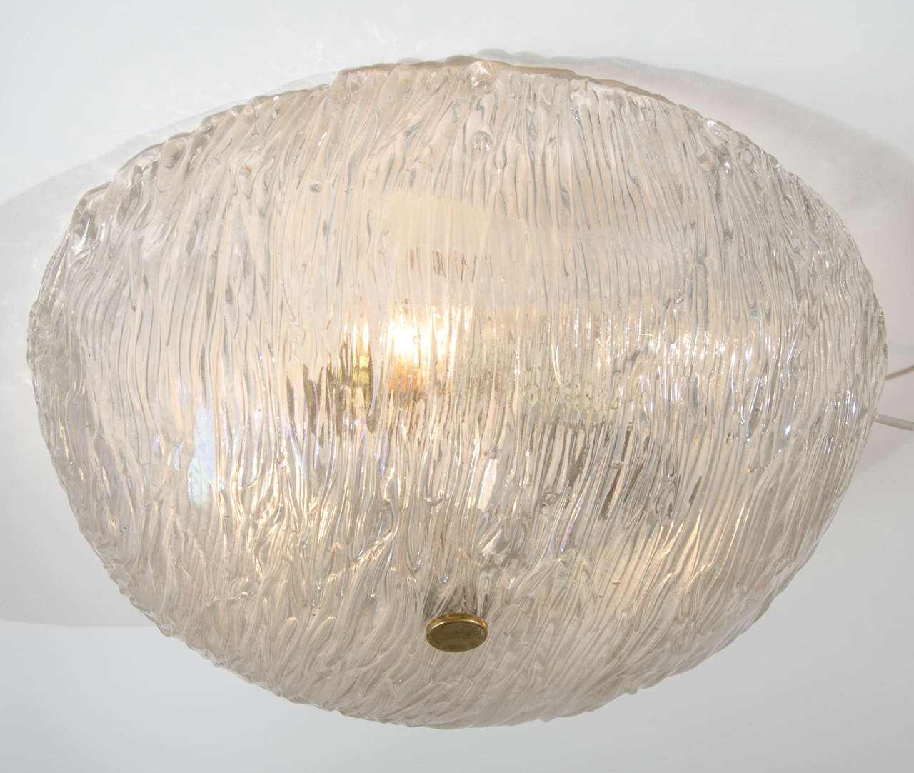 Hemisphere shaped glass dome with strings of layered tube glass sitting next to each other create a diffused light. The clear glass has iridescent surface color.