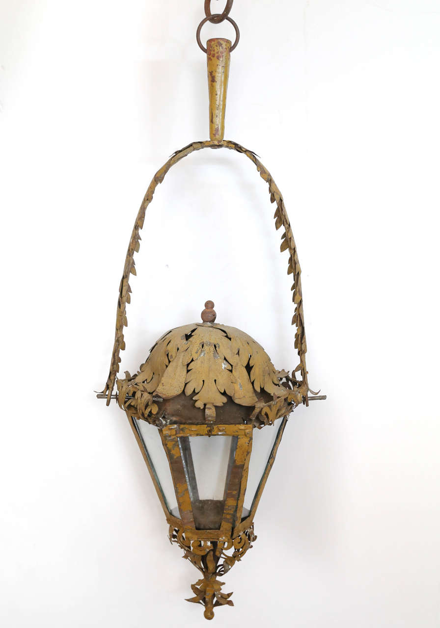 Processional lantern in painted tole with leaf design.