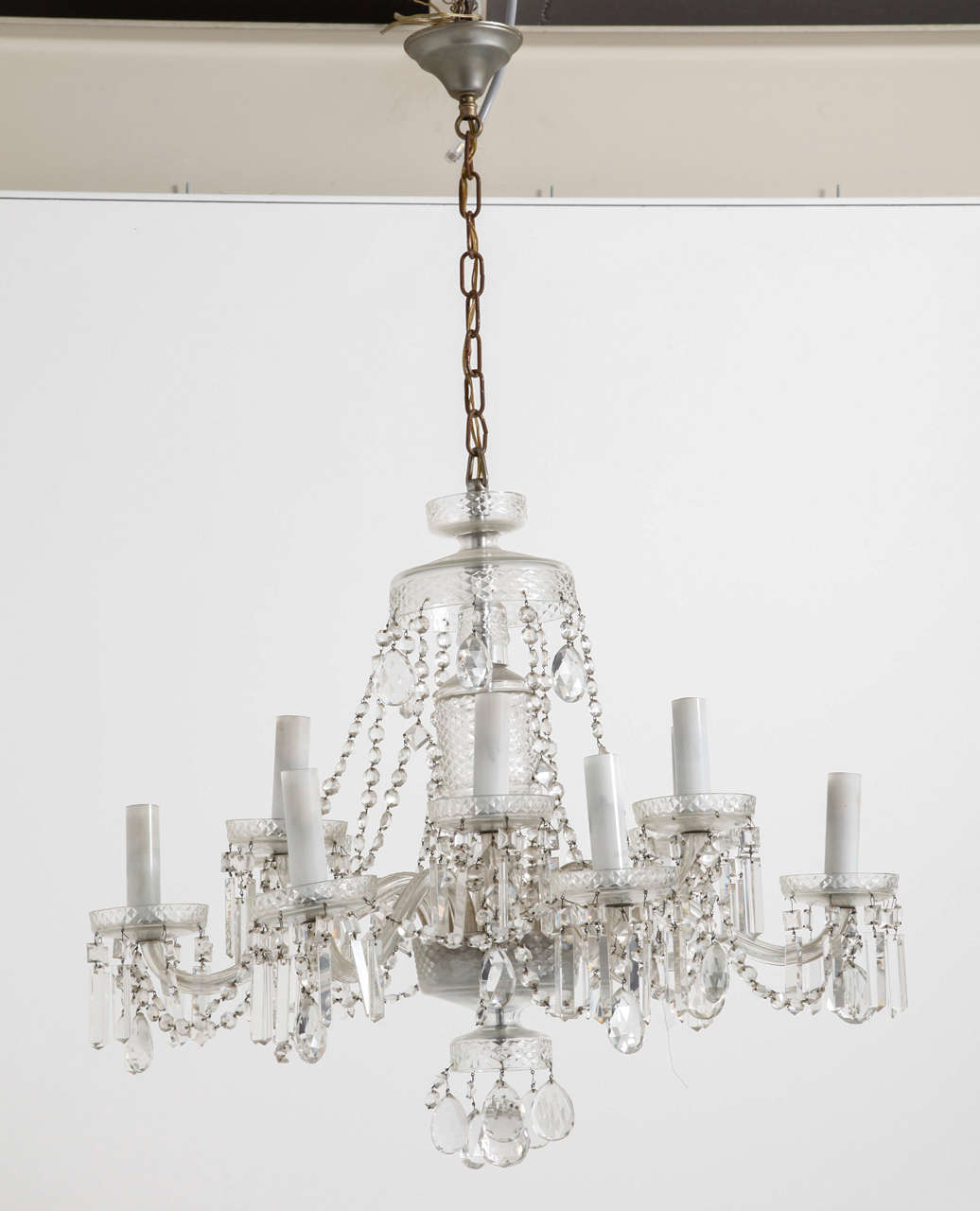 Twelve arms crystal chandelier with ornaments and opaline candlesticks, the crystal beads are all handcrafted that increase the quality of the chandelier due the reflection of light twinkling in the crystal parts.
Perfect original condition. Fitted