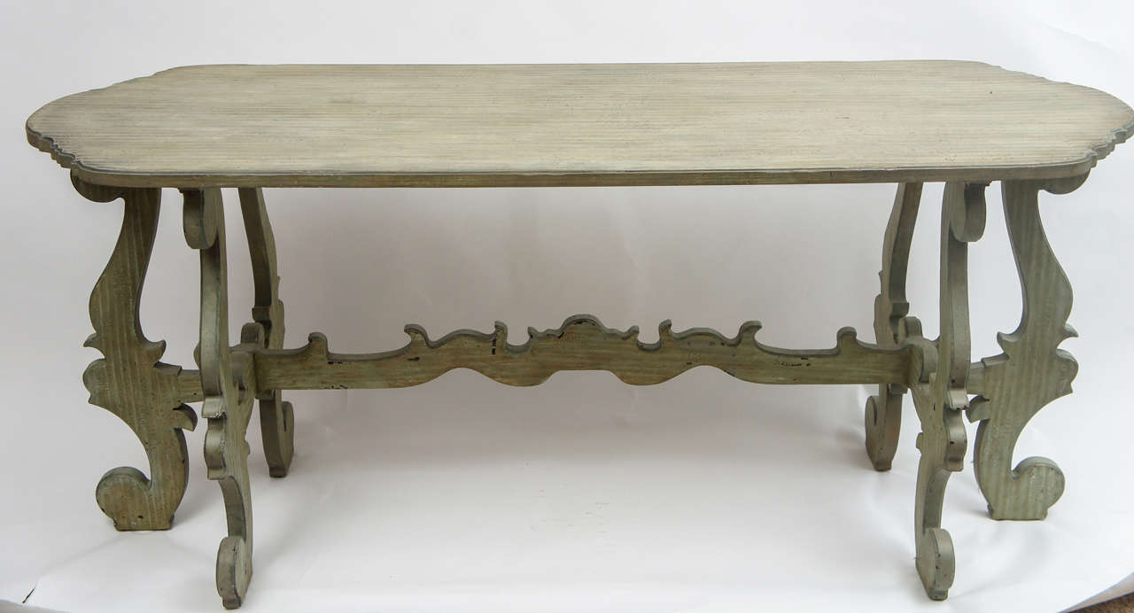 A curvy piece with uniquely shaped legs and stretcher, this painted console would be a great addition to the foyer, dining room, or behind a sofa. Minor evidence of paint loss and rippling to the top adds character and does not affect stability or
